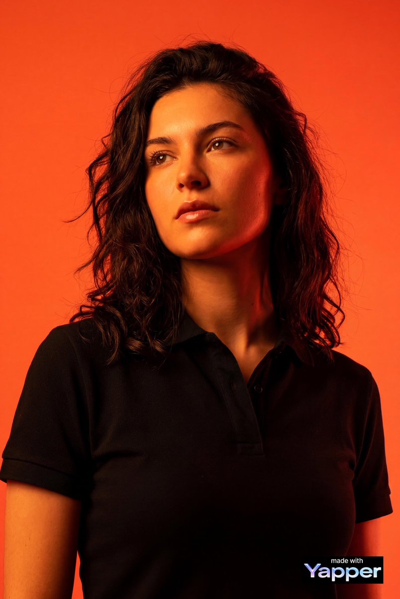 Create a high-impact editorial studio portrait using the person from the attached reference photo a…